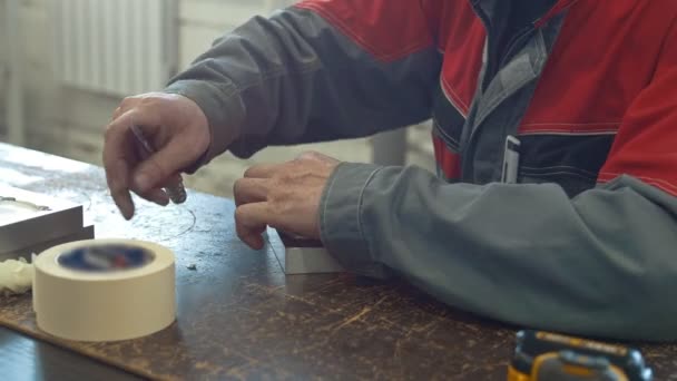 El hombre trabaja con un cuchillo con un detalle de metal para la fabricación de máquinas CNC — Vídeos de Stock