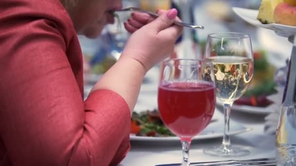 Volwassen vrouw eet schotel met een vork op het banket — Stockvideo