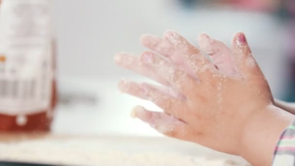 Hände eines kleinen Mädchens klatschen im Kochstudio in Mehl — Stockvideo