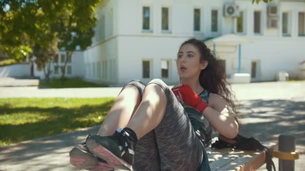 Young woman doing fitness exercises outdoors at sunny day — Stock Video