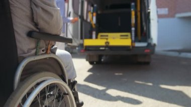 Kaldırma donanımları engellilerle - adam tekerlekli sandalyede arabada kaldırıncaya