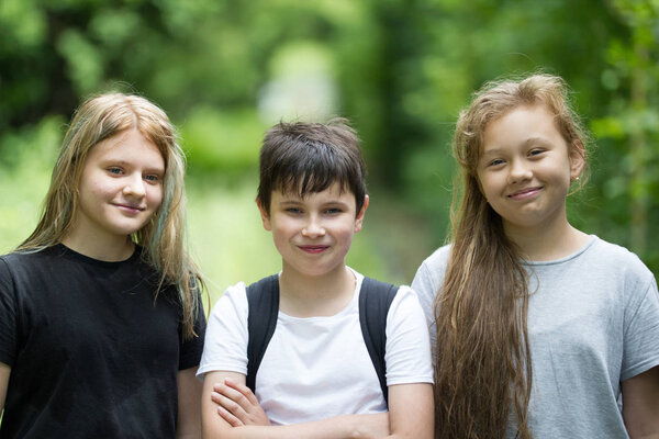 Children stand in the woods on an abandoned railway