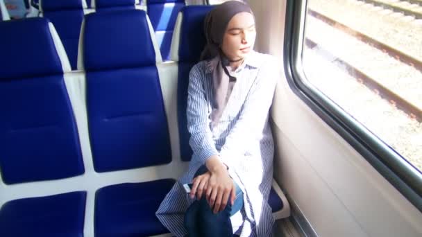 Two young muslim woman traveling by train — Stock Video