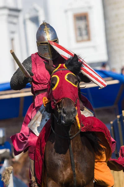 Bulgar, Federación Rusa - Agosto 2018, - un hombre con una armadura de caballeros y con un manto de Borgoña montando un caballo en un manto del mismo color participa en un festival medieval —  Fotos de Stock