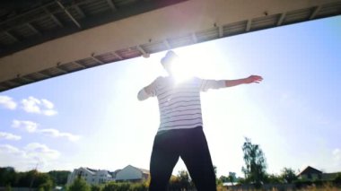 Bir genç atletik adam, Güneş'in arka sokaklarda haşhaş dans dansçı bazen güneş ile onun vücudu kapsar