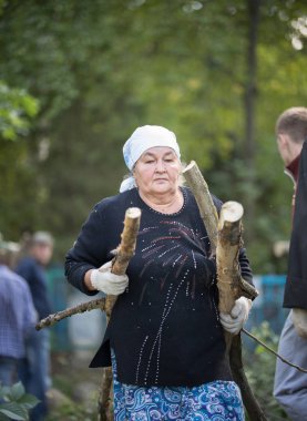 Tataristan, Rusya Federasyonu - 25 Ağustos 2018 - yaşlı kadın bir ormandaki bir kaç dal taşır