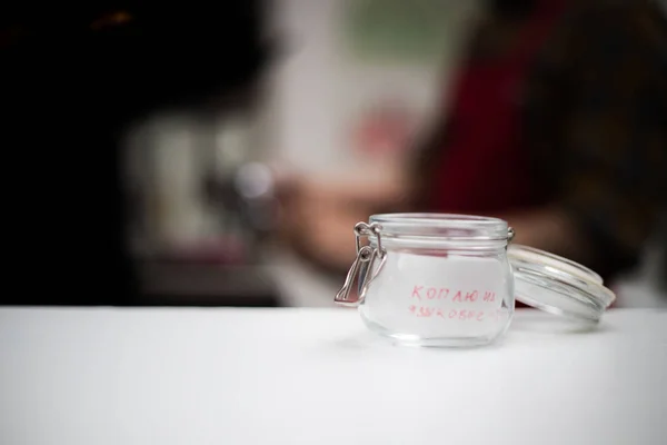 Tansparent cup för ett tips med en inskription i ett kaffehus — Stockfoto