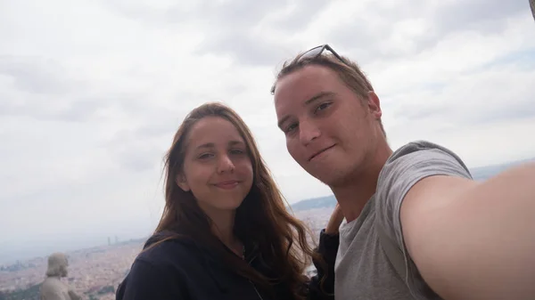 Una joven pareja tomando un selfie en la plataforma de observación. Vista aérea de Barcelona. Vista general de ciudad . —  Fotos de Stock