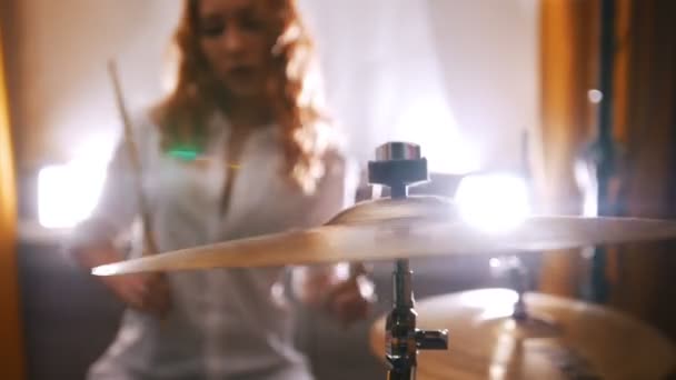 Wiederholung. Das rothaarige Mädchen spielt Schlagzeug. Fokus vom Schlagzeug bis zum Mädchen — Stockvideo