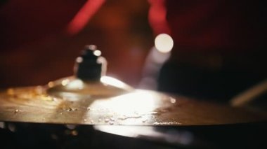 Repetition. Close up of hi-hats. Girl playing drums