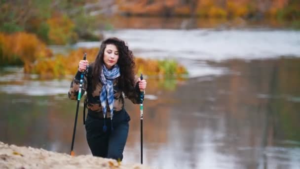 Junge hübsche Frau beim Wandern. Skandinavischer Spaziergang. — Stockvideo