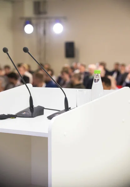 Two microphones at the table and bottle of water. Business conference — Stock Photo, Image