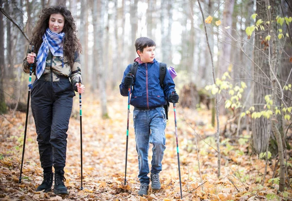 Caminar nórdico. Niño y mujer joven — Foto de Stock