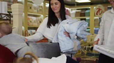 Alışveriş bir aile. Biraz yatak, oynayan bebekler anne onlarla oynamak