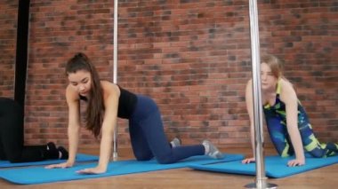 Genç kadın bir stüdyoda ısınıyor. Bükme geri