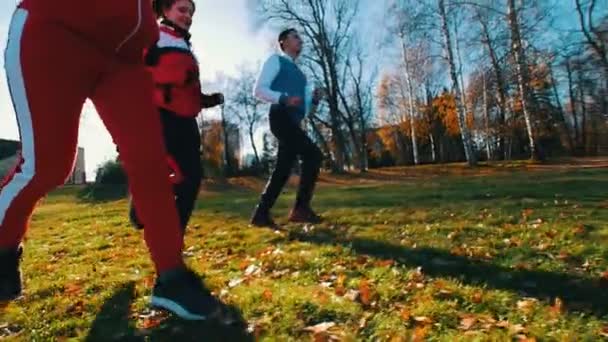 Jovens a correr no parque. Movimento lento — Vídeo de Stock