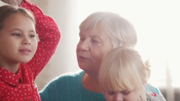 Drandmother и внучки позируют перед камерой — стоковое видео