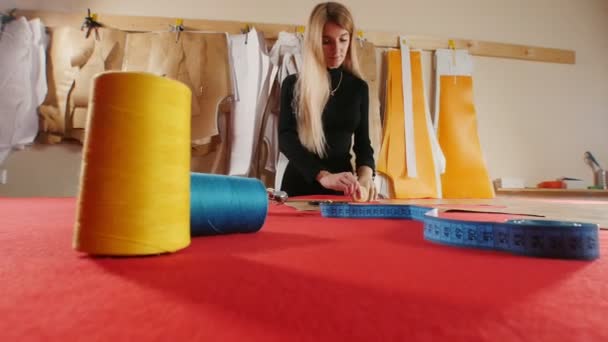 Jeune femme avec prothèse de bras faisant des croquis sur le tissu — Video