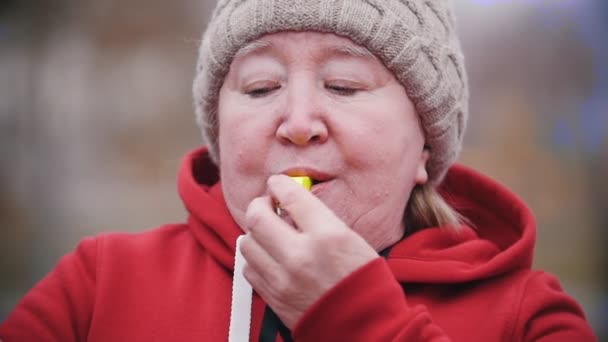 Una anciana sopla poderosamente en silbato . — Vídeo de stock