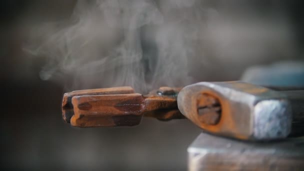 Water evaporates from the forceps. Blacksmith workroom. Close up — Stock Video