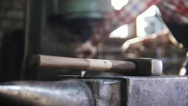 Blacksmith getting a red-hot top of the axe. Hammer in focus — Stock Video