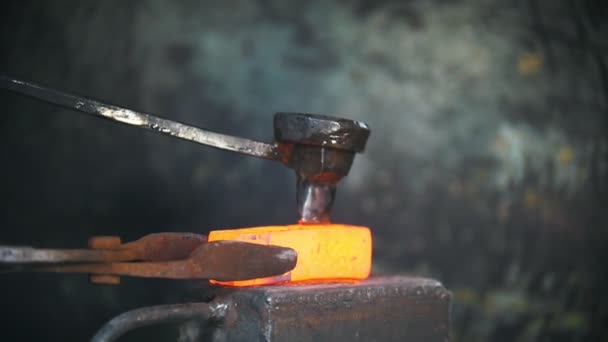 Blacksmith working with electric hammer on the anvil, man making holes in red hot steel, craft — Stock Video