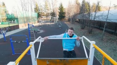 Genç adam bir çubuk üzerinde asılı