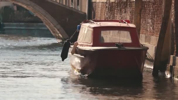 En motorbåt på en liten kanal i centrala Venedig — Stockvideo