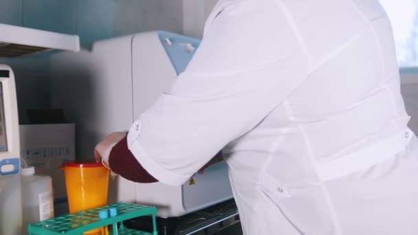 Klinik medis. Perawat menempatkan sampel darah dalam mesin . — Stok Video