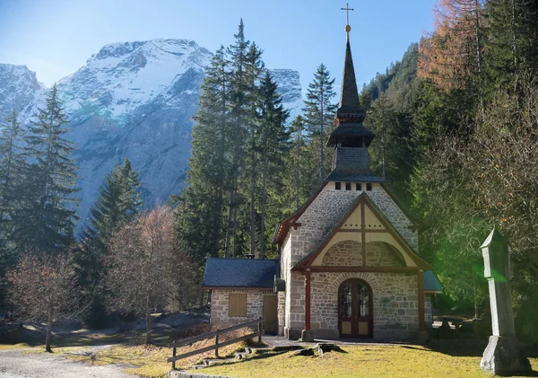 Traveling. A church in the depths of a forest. Alpine mountains on the background — Stock Photo, Image