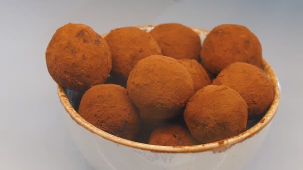 Chocolate truffle sprinkled dark chocolate in the bowl — Stock Video