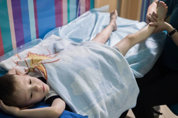 Clínica médica. Uma ocupação com criança com paralisia cerebral. Massagem relaxante nos pés — Fotografia de Stock