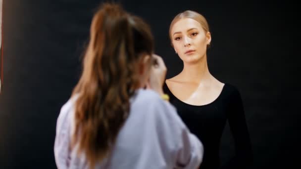 Модели в студии. Молодая женщина-модель позирует фотографу — стоковое видео