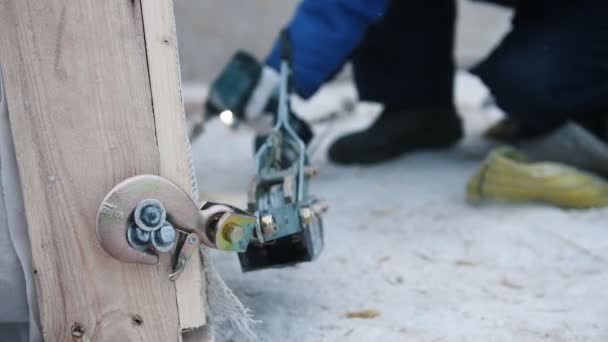 Site de construction. Le crochet de la grue industrielle accroché à la partie en bois sur la construction — Video