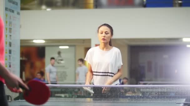 Junge Frau nimmt den Ball an, ihre Gegnerin scheitert. Tischtennis — Stockvideo
