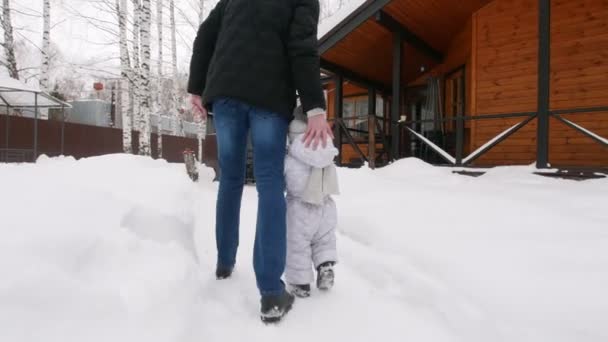 Ung familj gå på innergården. En liten baby promenad till hans mor — Stockvideo