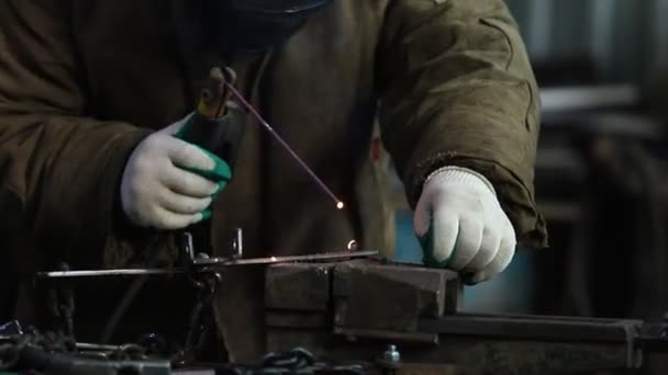 Welding process. A man worker attaching a small detail by welding — Stock Video
