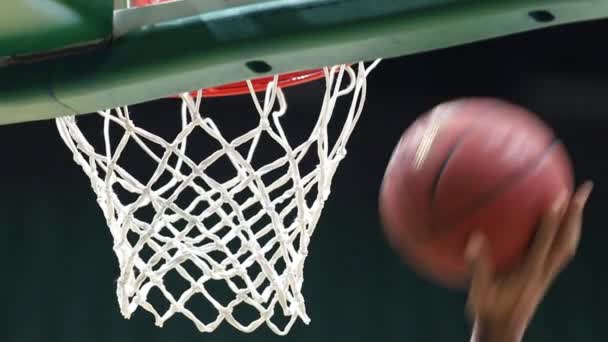 Einen Ball in einen Basketballkorb werfen. Der Ball landet genau im Tor. — Stockvideo