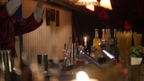 Jeune barman professionnel versant des coups de liqueur rouge — Video