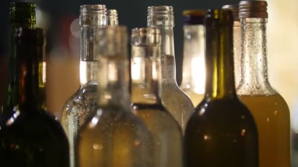 Primer Plano Botellas Llenas Alcohol Diferentes Colores Barra Con Iluminación — Vídeos de Stock