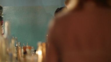 Kırmızı bir içki kokusu ve barın arkasında başka bir barmenle konuşmaya genç profesyonel barmen