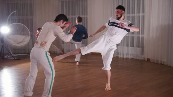 Capoeira. Sparring. A group of smortsman training their skills — Stock Video