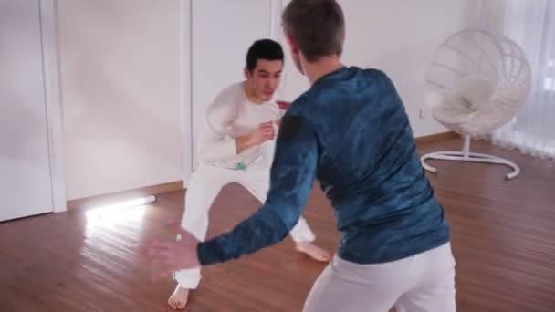 Martial arts. Capoeira. Two young men training — Stock Video