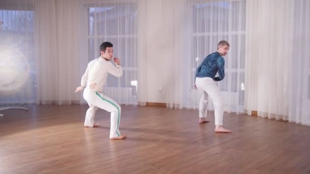 Бойові мистецтва. Два акробатичні чоловіки виконують елементи капоейри — стокове відео