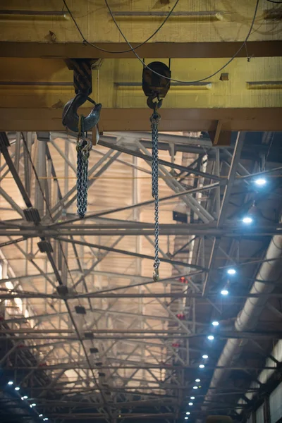 An overview on construction site inside the manufacturing plate. A chain hanging on a hook