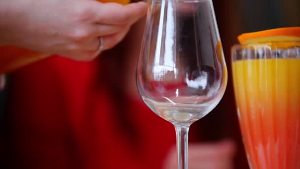 A restaurant food. A person pouring the drink in the glass. A woman takes it and drink — Stock Video