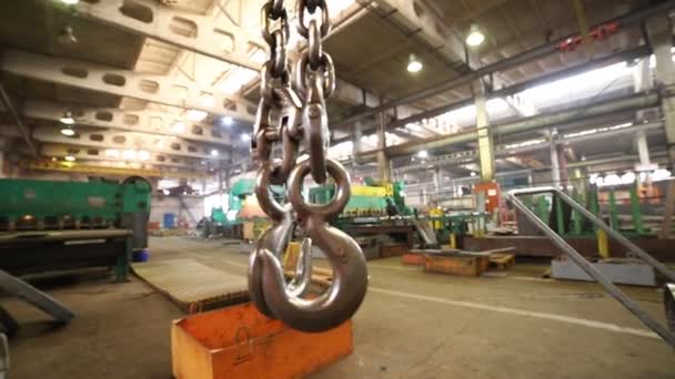 Industrial concept. Construction plant. A big lifting hook hanging in the air — Stock Video