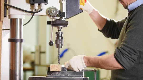 Perforadora industrial - trabajador hace agujeros en metal —  Fotos de Stock