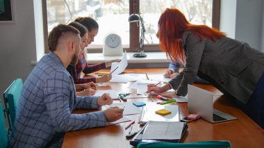 İş kavramı. Bir çalışan ekip Konferansı'nda. Zencefil bir kadın masada kağıtları bakmaya gider