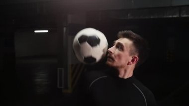 Omuz ile topa vurmak ve alnında topu yakalamak genç bir futbol adam